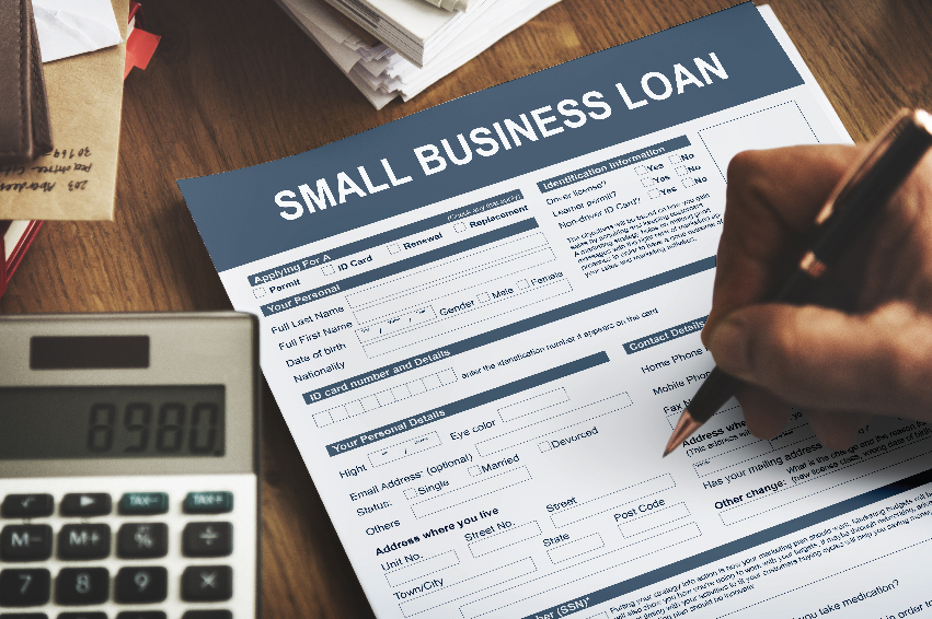 A businessman filing a form for Small business loans in UAE.