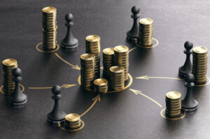 Coins and pawns illustrate the concept of various funding sources for startups.