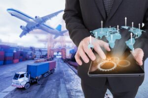 The concept of global trade coverage is illustrated by a businessman holding a tablet with a logistics import and export background.